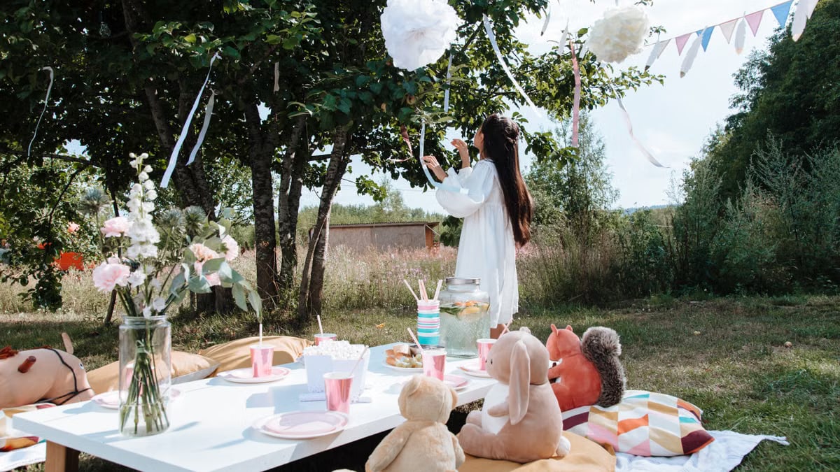 Child's outdoor birthday party with picnic setup and decorations.